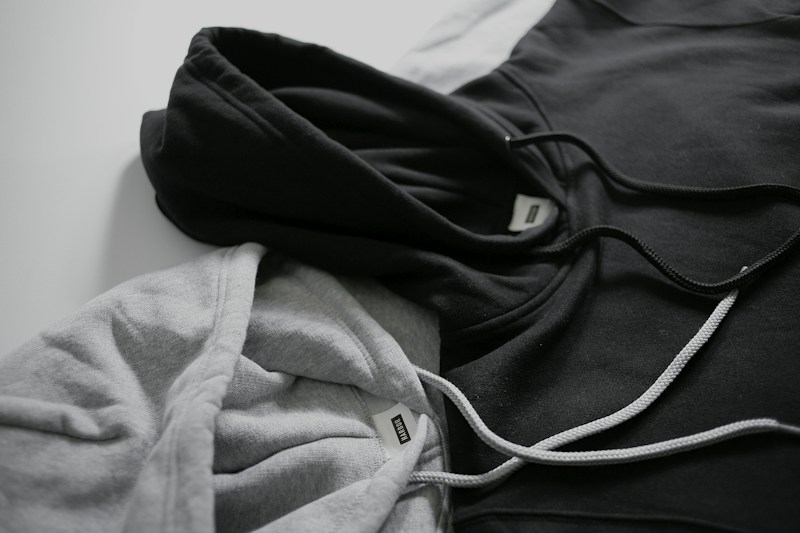 Black and gray hoodie flatlay