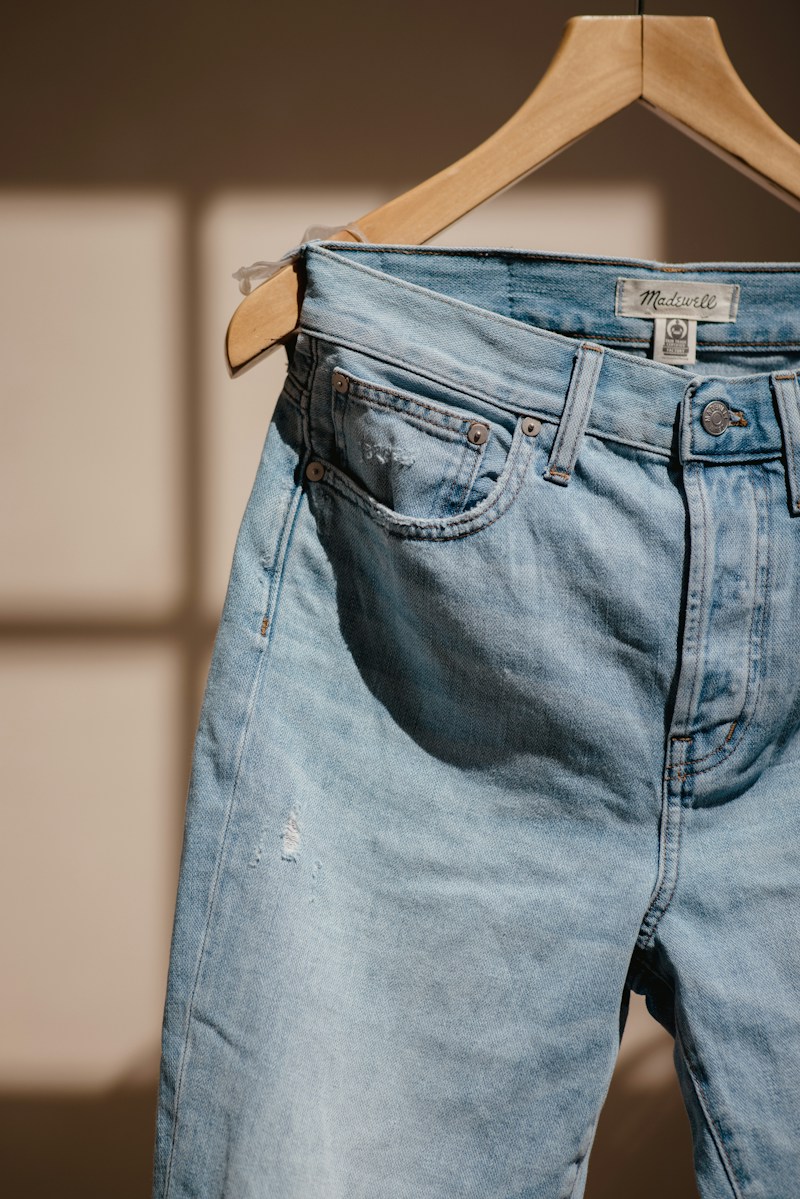 Blue jeans hanging, front view